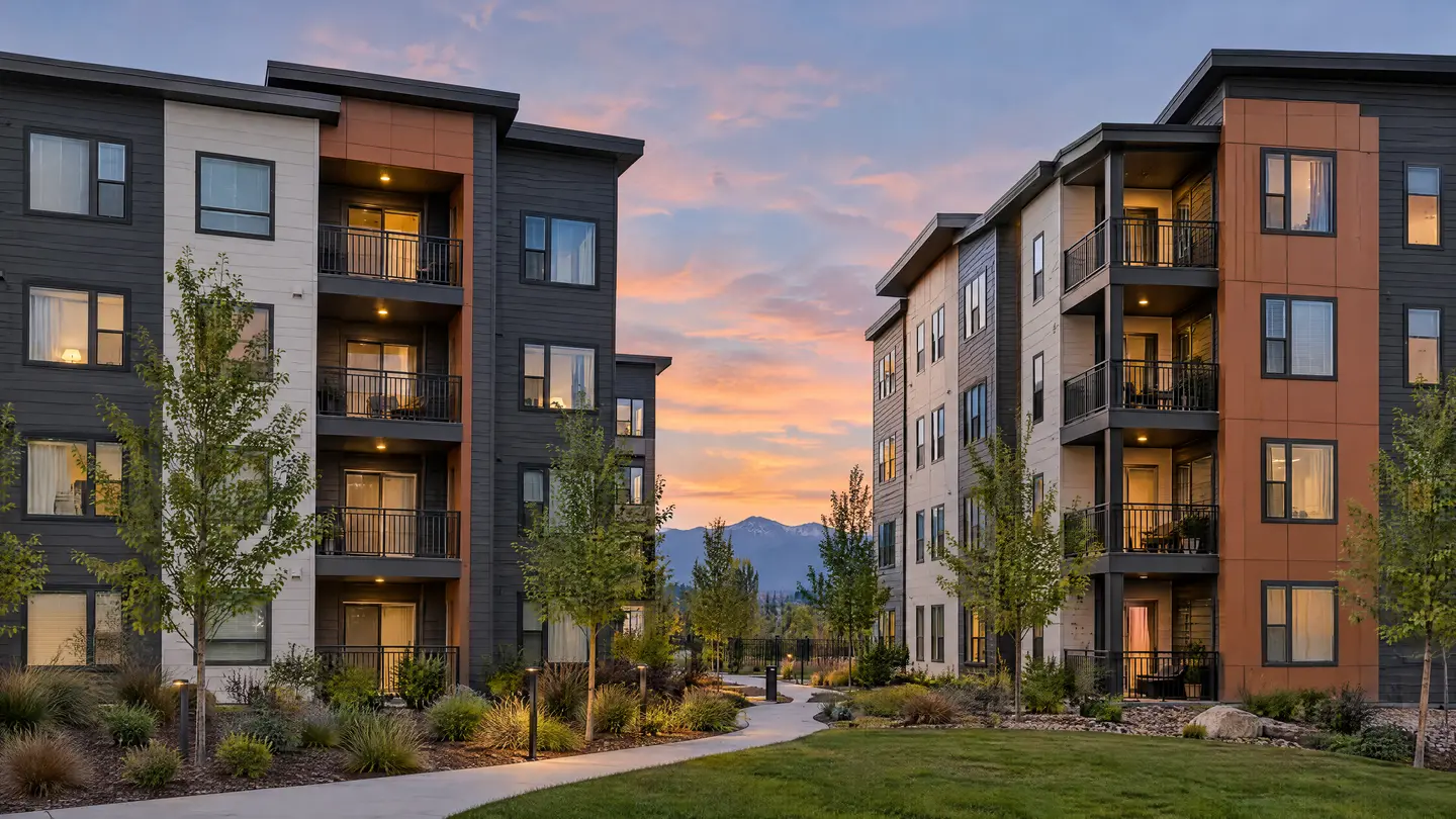 Repainted mid-rise apartment buildings with balconies at dusk